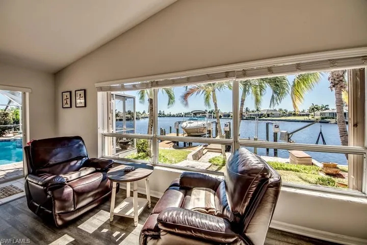 Sunroom with a water view and vaulted ceiling