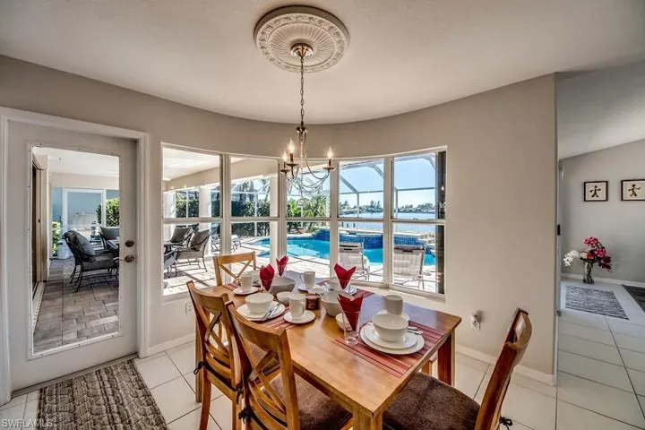 Dining area featuring a chandelier and light tile patterned floors