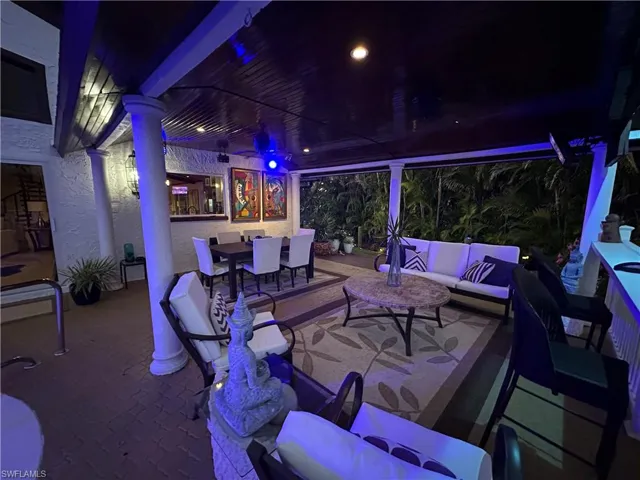 Patio at night featuring an outdoor living / dining area and a patio area