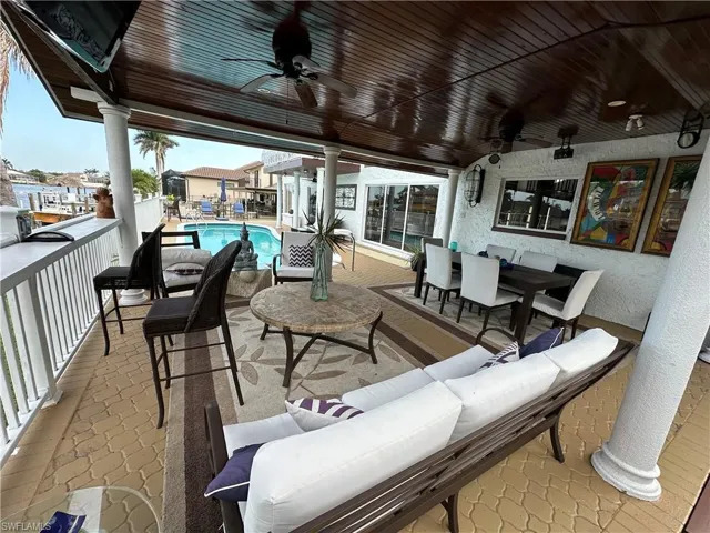 View of patio / terrace featuring an outdoor living / dining area and a ceiling fan