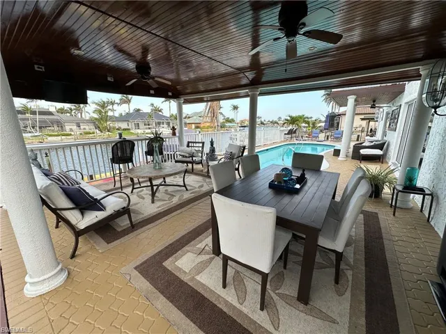 View of patio with ceiling fan, outdoor lounge area, and a residential view