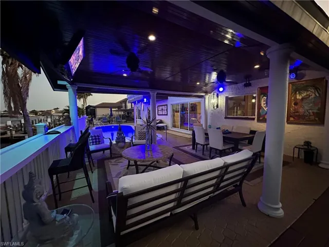View of patio with outdoor lounge area and a community pool