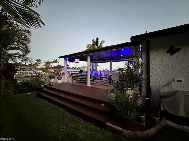 Deck with a yard, area for grilling, and an outdoor hangout area