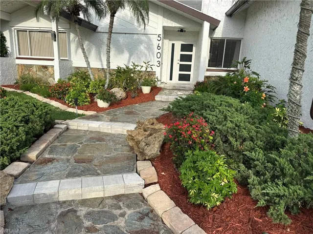 Property entrance featuring stucco siding
