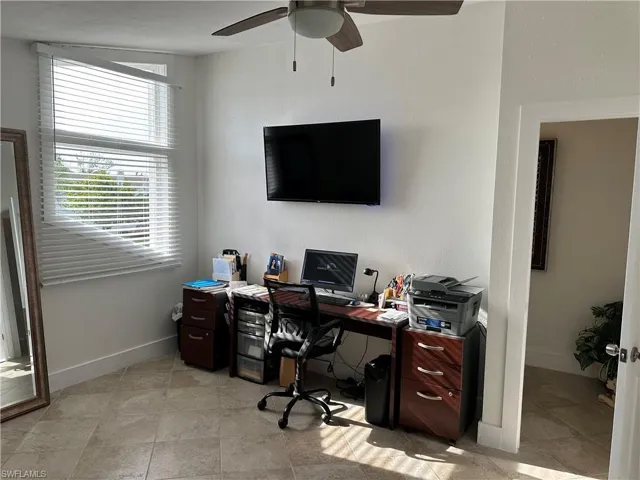 Office featuring a ceiling fan and baseboards