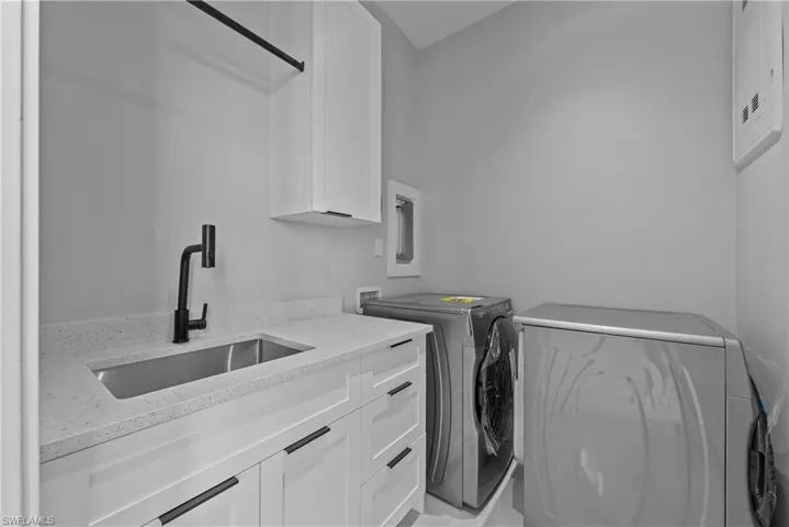 Laundry room featuring cabinet space and washer and dryer