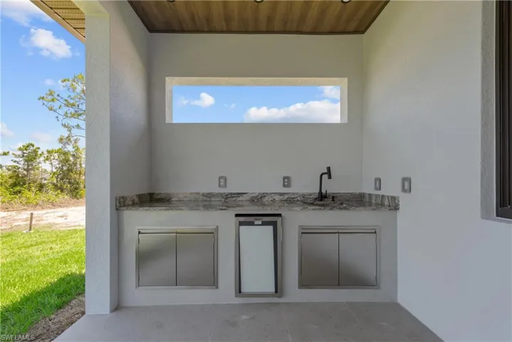 View of patio / terrace featuring an outdoor kitchen and a sink