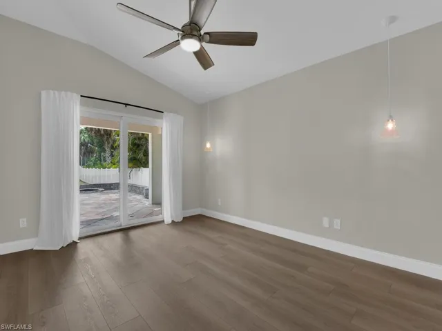 Master bedroom feature lots of natural light with impact glass sliders with a backyard view.