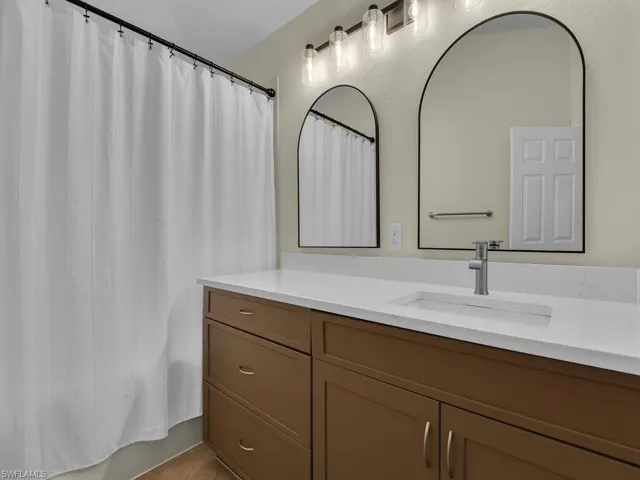 Master Bath with double vanity and updated lighting, linen closet and separate toilet room