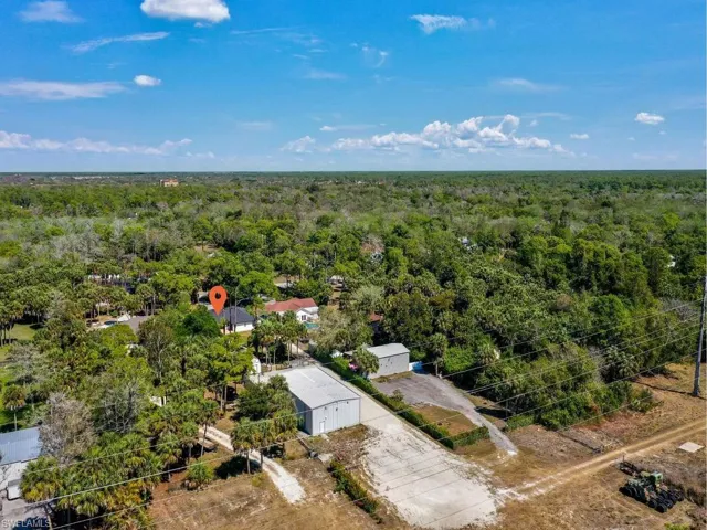 Ariel view of home extending all the way back to show warehouse in back of property with additional storage and ample parking space for boats, RV and more!