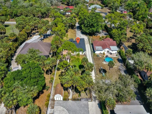 Aerial View of the front of property, backyard, storage shed that comes included, basketball court and extra parking for boats, RV & More!