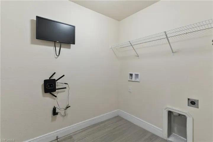 Washroom featuring hookup for a washing machine and electric dryer hookup
