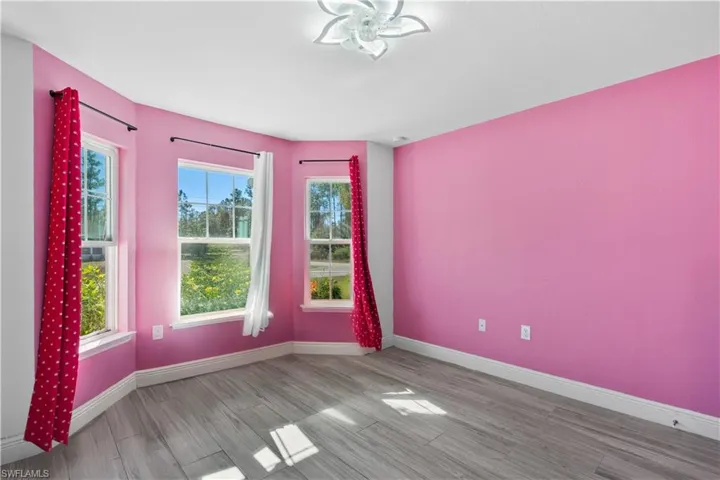 Empty room featuring wood finished floors and baseboards