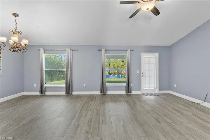 Unfurnished room with a chandelier and light wood-style flooring