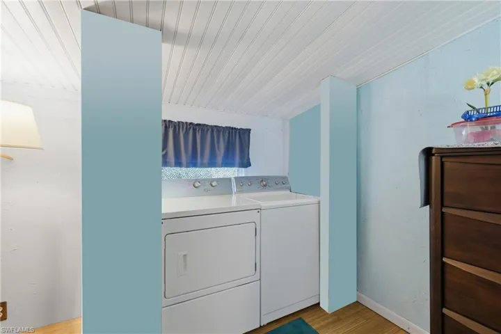 Laundry area featuring washing machine and dryer and light wood-style floors