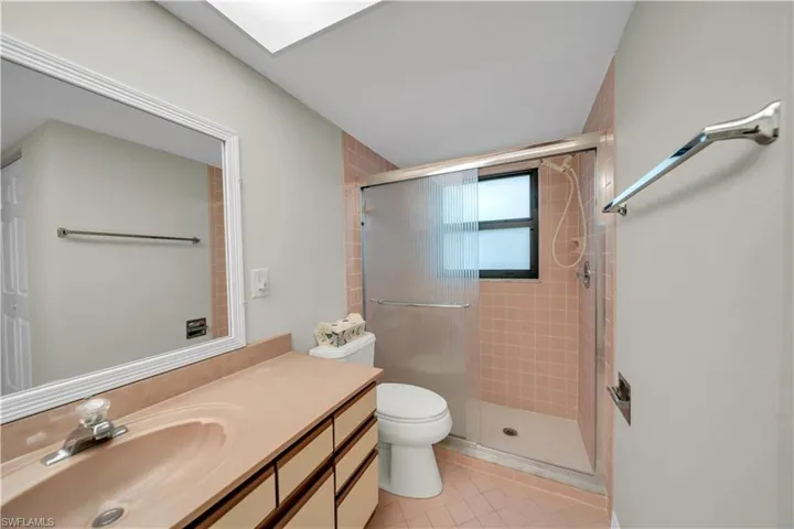 Bathroom with a shower stall, vanity, and light tile patterned floors