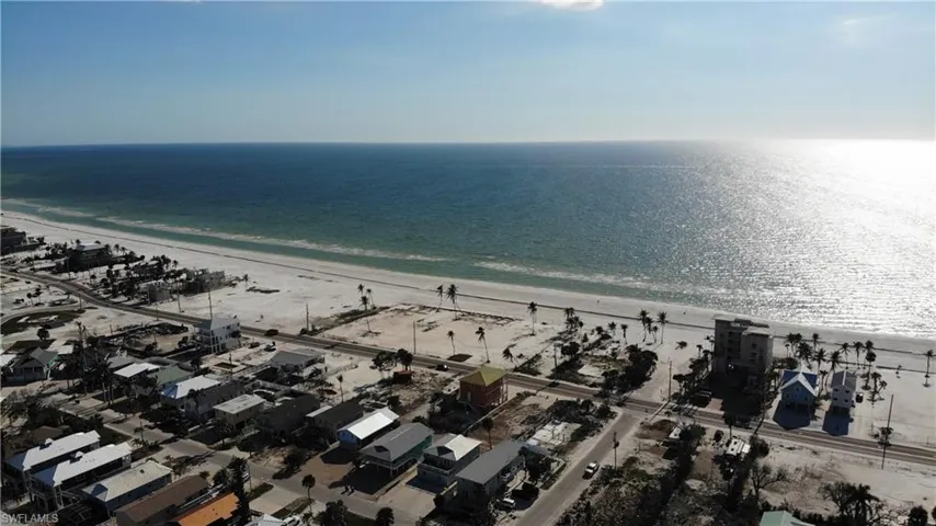 Drone / aerial view with a water view and a beach view