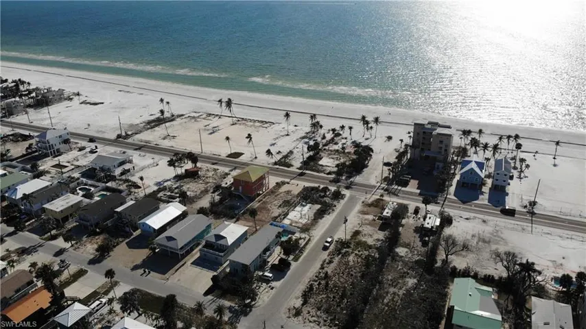 Drone / aerial view featuring a beach view and a water view