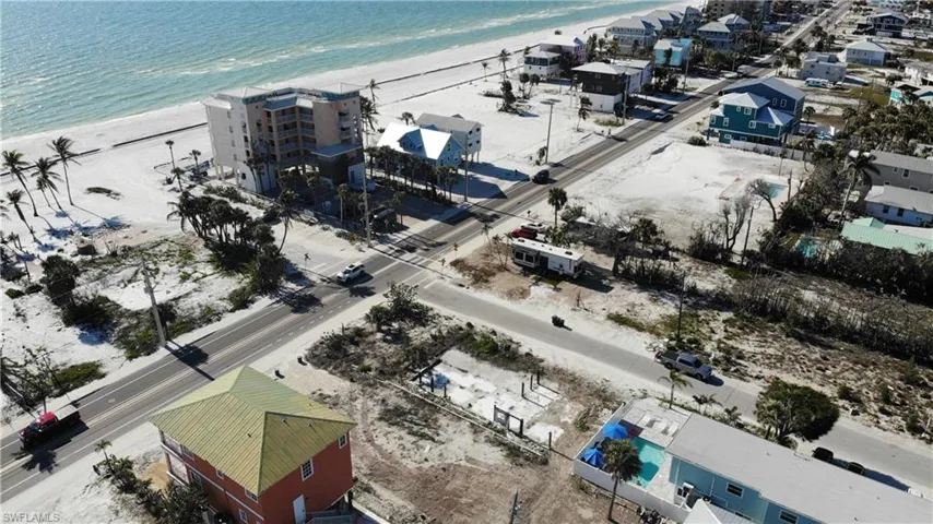 Drone / aerial view featuring a beach view and a water view