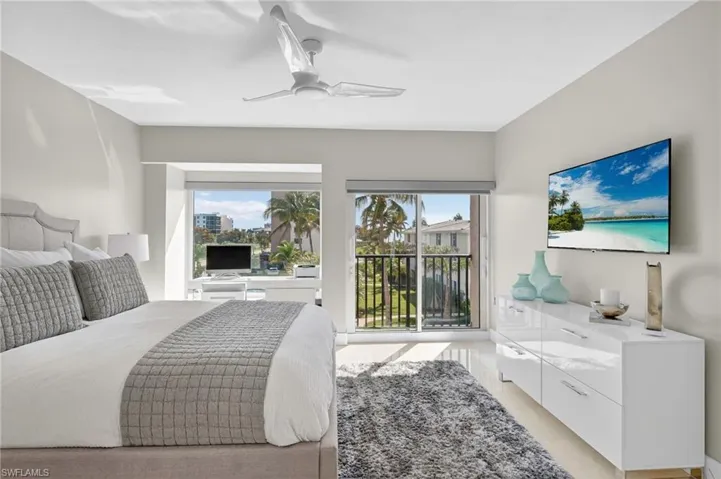 Bedroom with a ceiling fan and light tile patterned floors