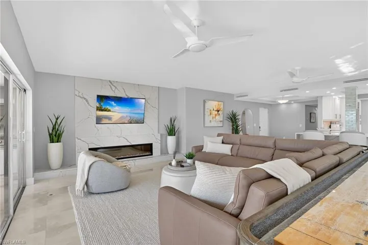 Living room with ceiling fan and a premium fireplace