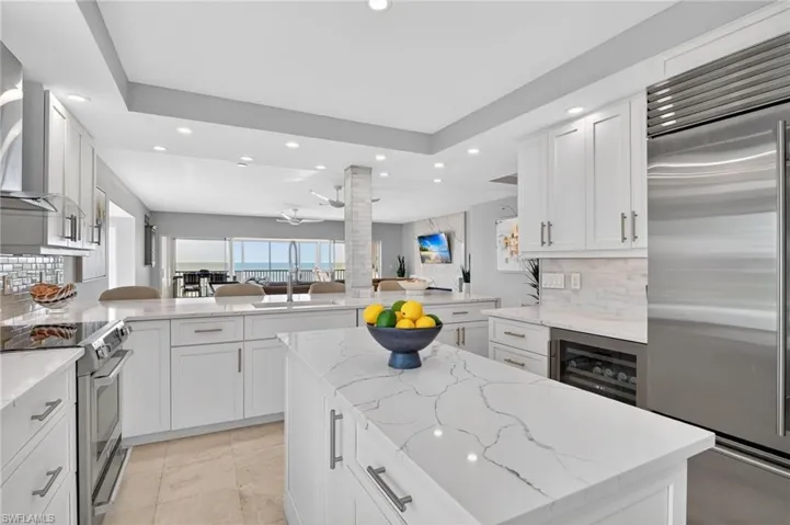 Kitchen featuring decorative backsplash, open floor plan, recessed lighting, stainless steel appliances, and a peninsula