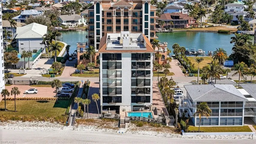 Aerial perspective of suburban area featuring a nearby body of water