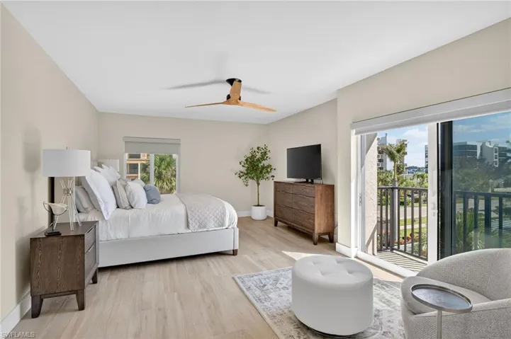 Bedroom featuring light wood-style floors, access to outside, and ceiling fan