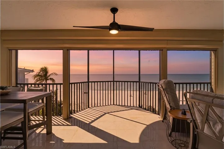 Sunroom featuring a water view