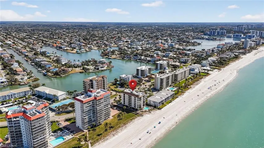 View of property location featuring unending shoreline and nearby urban area