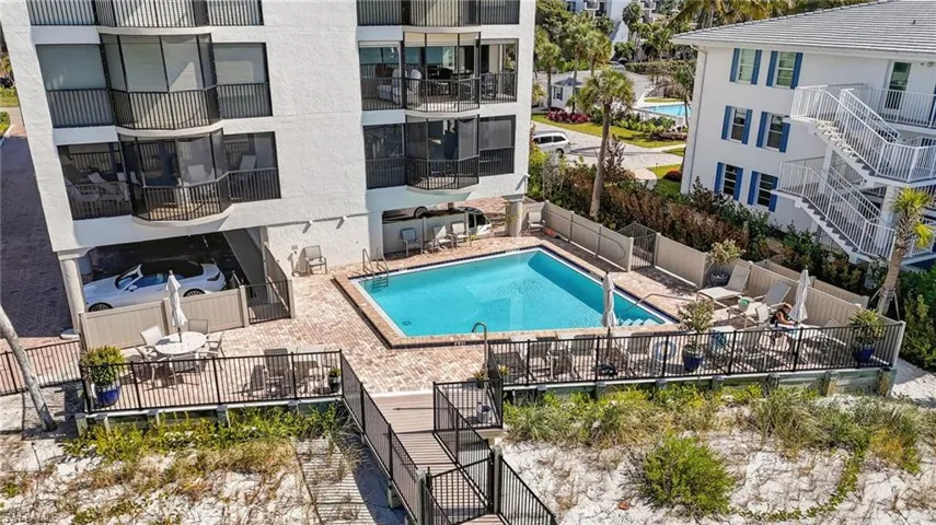 Community pool featuring stairway and a patio