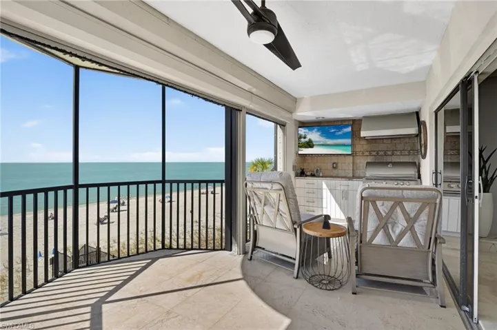 Sunroom featuring a beach view