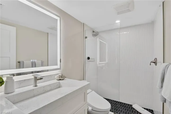 Bathroom with walk in shower and vanity
