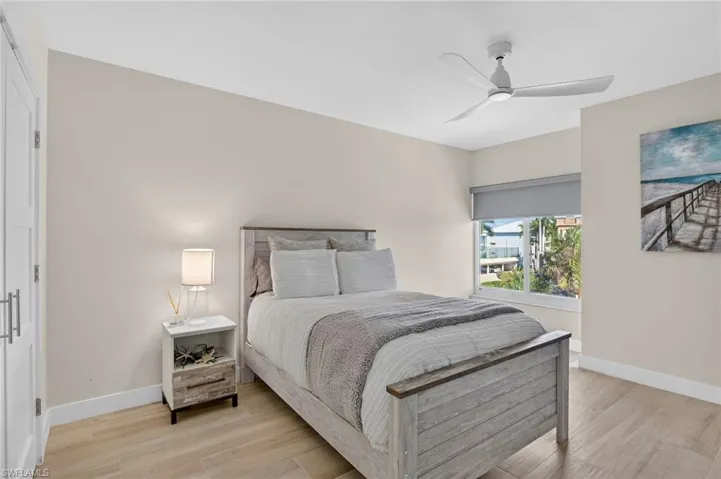 Bedroom with light wood-style floors and a ceiling fan