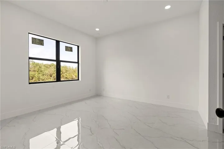 Unfurnished room with recessed lighting and light marble finish flooring