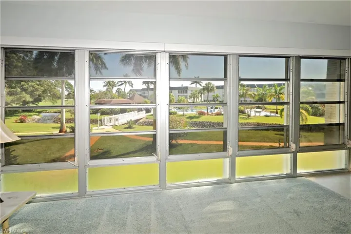 Terrific view of clubhouse and amenities from your enclosed lanai. Electric Blinds on Lanai windows. Hurricane shutters for lanai windows and  all windows.