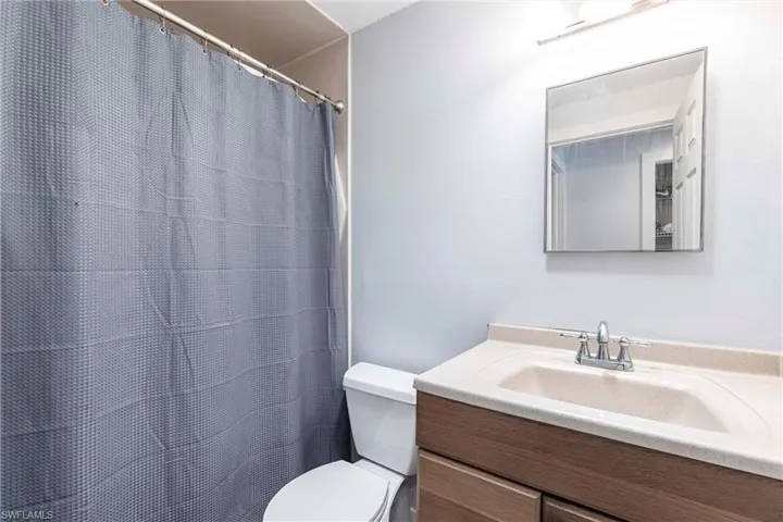 Full guest bath featuring vanity and a shower with shower curtain