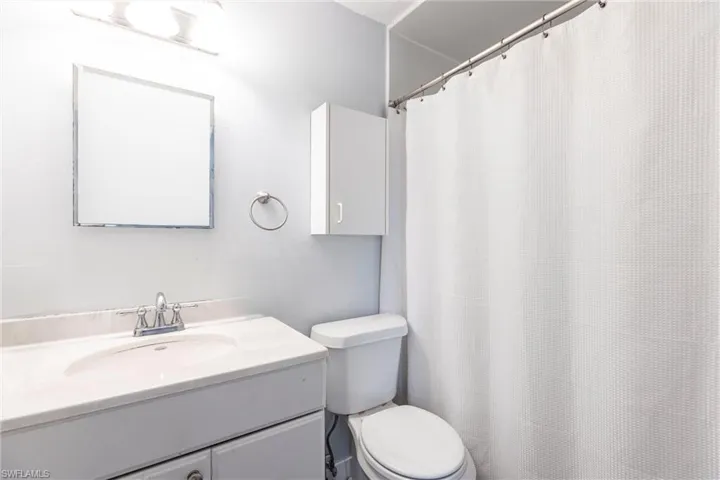 Primary bedroom bath featuring vanity and a shower with shower curtain