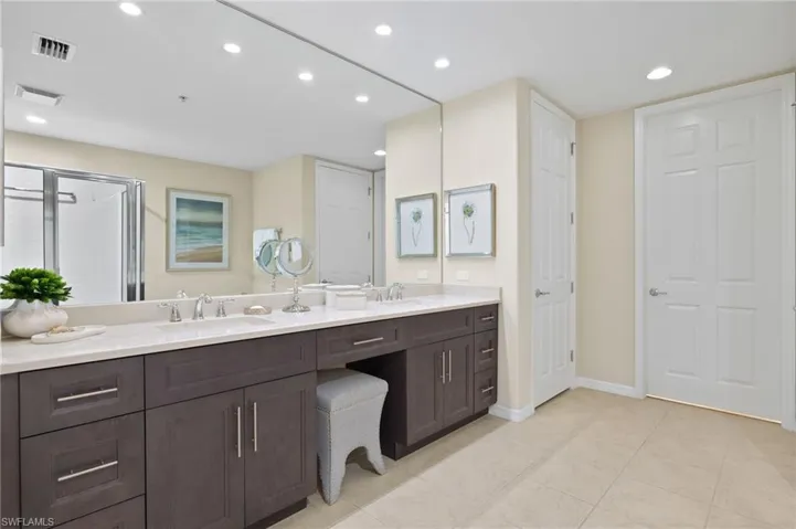 Bathroom featuring double vanity and tile patterned flooring