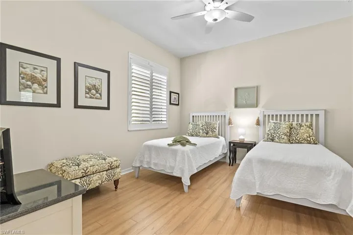 Bedroom featuring ceiling fan and light hardwood / wood-style flooring