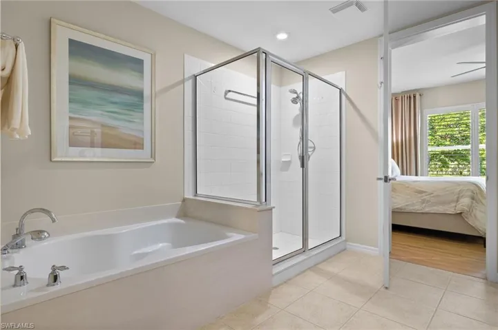 Bathroom with independent shower and bath, ceiling fan, and hardwood / wood-style floors