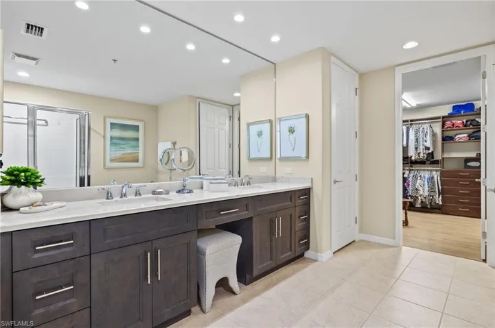 Bathroom with double vanity and tile patterned floors