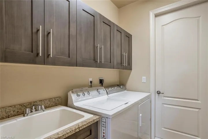 Laundry room featuring a sink and washing machine and clothes dryer