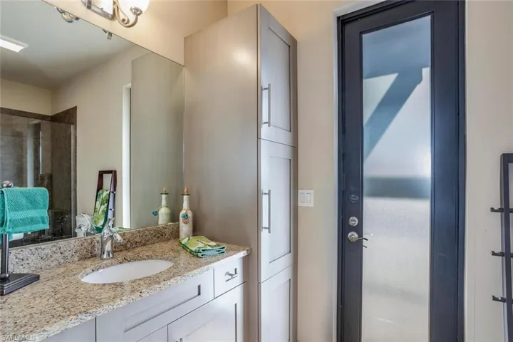 Full bath with vanity and tiled shower