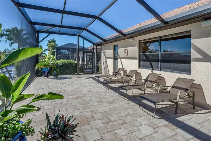 View of patio featuring glass enclosure and a sunroom