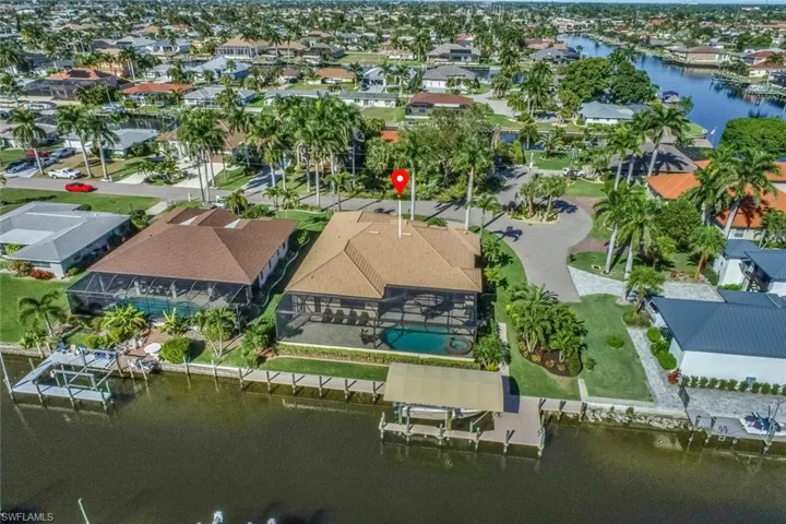 Aerial view of property's location featuring a large body of water and nearby suburban area