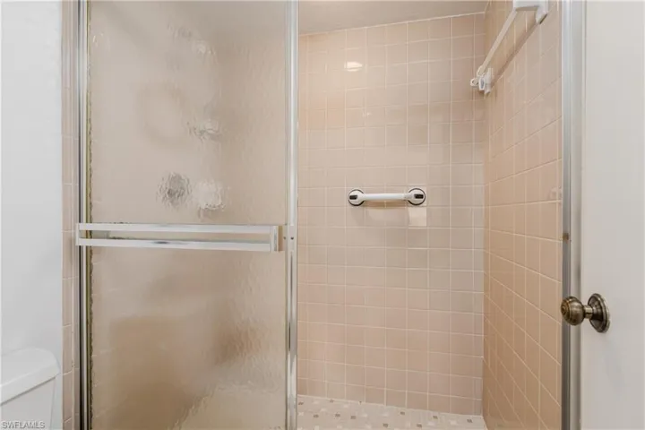 Walk-in tiled shower in main bathroom