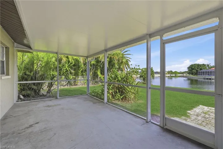 Unfurnished sunroom with a water view
