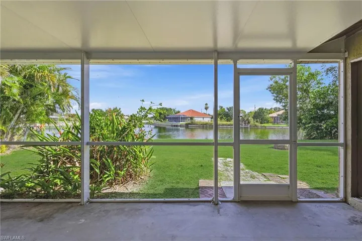 Unfurnished sunroom featuring a water view and plenty of natural light