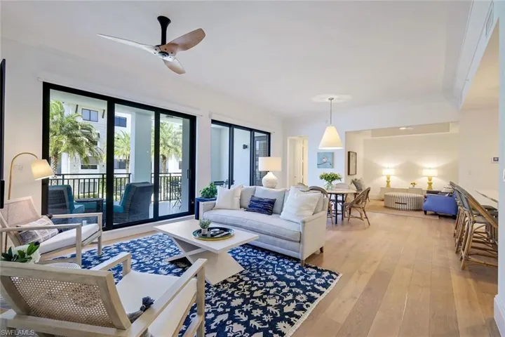 Spacious living room featuring Legno Bastone wood floors throughout home